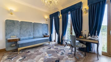 Deluxe Suite | Living area | 43-inch TV with cable channels