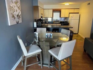 A modern kitchen with a dining area.