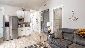A modern kitchen with white cabinets, stainless steel appliances, and a wooden backsplash. - Summer Kickoff Special! Beach House on 30A, Steps from the Beach! (Santa Rosa Beach)