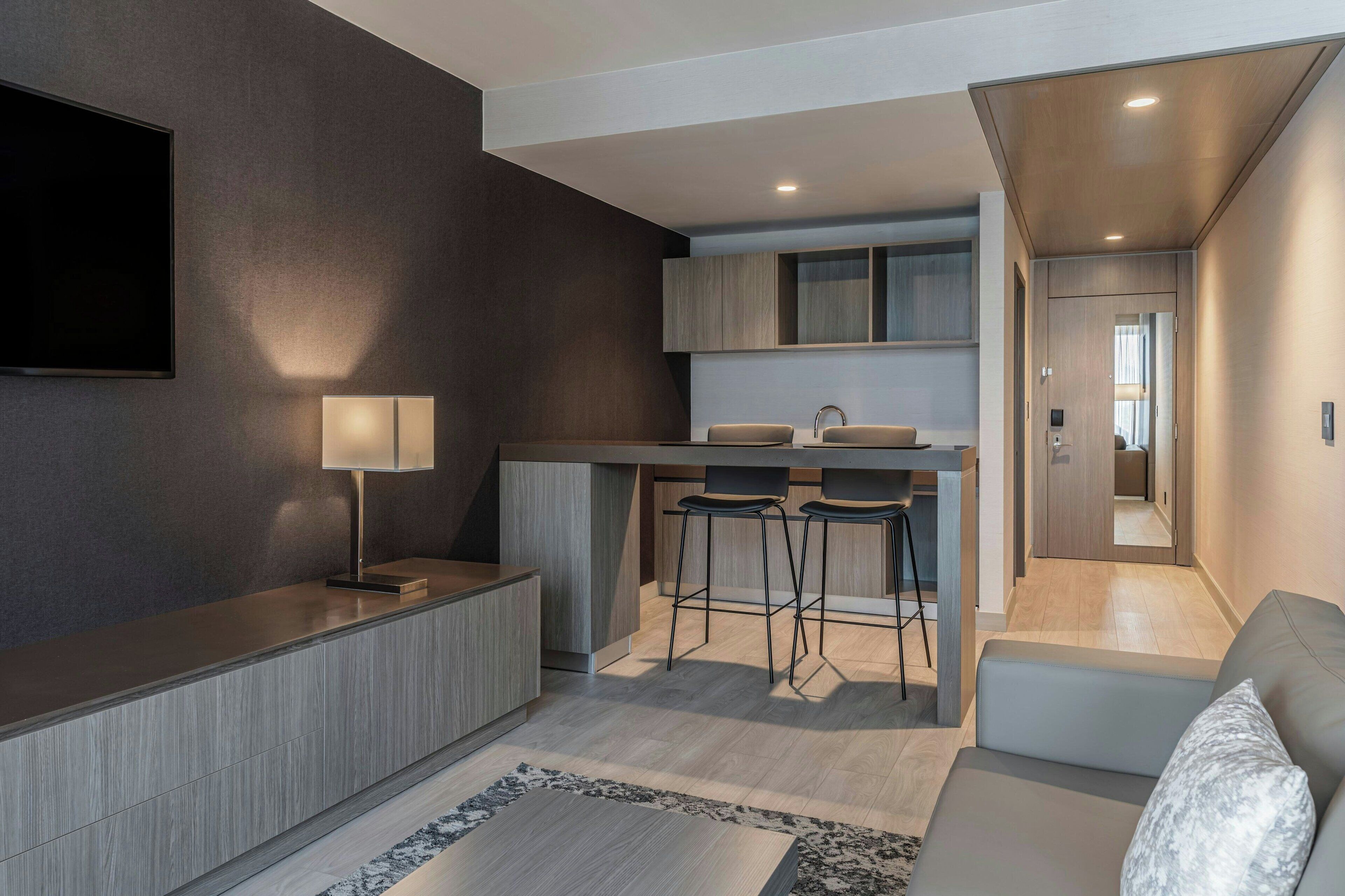 suite, 1 bedroom, non smoking | living area | led tv, books