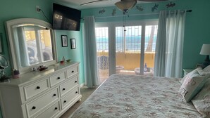 Une chambre à coucher avec un lit, une commode et un ventilateur de plafond.