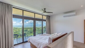 A bedroom with a large window, a ceiling fan, and an air conditioning unit. - Luxurious Modern Villa with infinity pool- 5 min to the beach (Nosara, Costa Rica)
