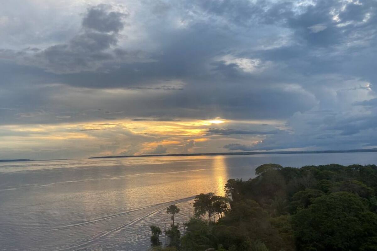 A coastal landscape with a body of water reflecting the sky.