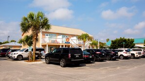 A parking lot with several SUVs and a building with a sign that reads "Tow Away Zone".