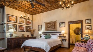 A bedroom with a wooden bed, a wooden ceiling, and framed pictures on the walls. - Suite Milena, luxury and comfort close to the malecon. Breakfast included (La Paz)
