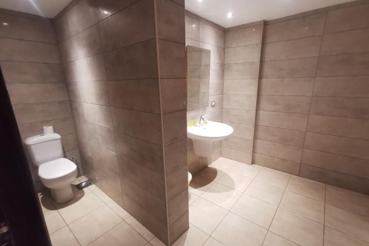 Bathroom | Rainfall showerhead, towels, soap, shampoo