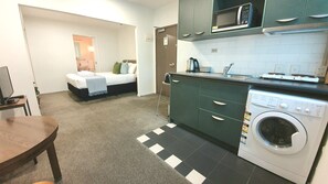 Cozy retreat with a bed, kitchenette, and convenient amenities.