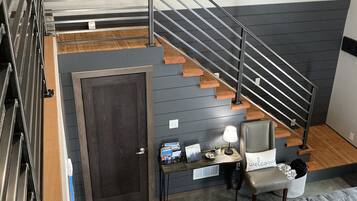 A modern interior with a staircase, a dining area, and a living space.