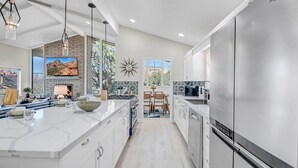 A modern kitchen with a large island, stainless steel appliances, and a view of the outdoors. - Breathtaking Views, Ideal Location, Peaceful Lounging Area (Sedona)