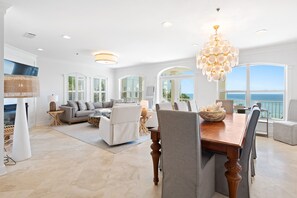 A spacious living room with a large dining table, comfortable seating, and a view of the ocean. - Villa on the Beach Heated Pool Gated Community in Seacrest Next to Rosemary+Alys (Panama City Beach)