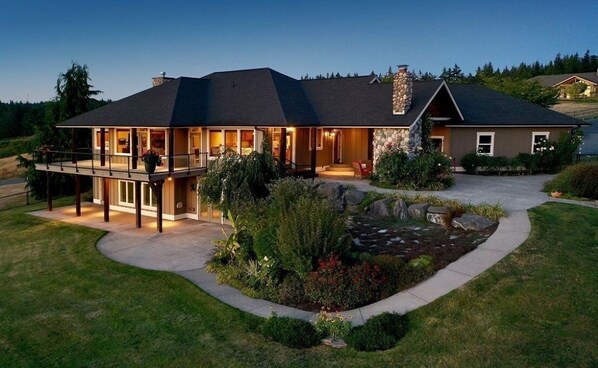 Stunning two-story home with a charming porch and beautifully landscaped garden.