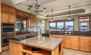 Enjoy cooking in this well-equipped kitchen with a central island, gas stove, and ample counter space.