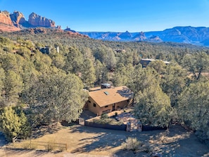 Escape to a serene retreat surrounded by lush forests and striking red rock formations.