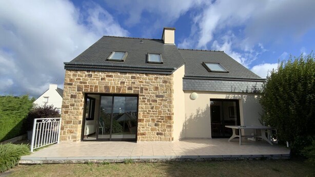 A two-story house with stone walls, large glass doors, and a patio area. - House with terrace in Erquy | 6 guests | Ref 603 (ERQUY)