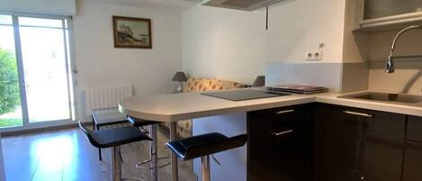 Een koelkast, een magnetron, een oven, kookgerei, borden en bestek