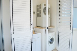 A laundry room with a washing machine, a dryer, and a ventilation unit. - Cerrano Park B11 - Africo - Apartment with terrace and with Seaview (Foggetta)