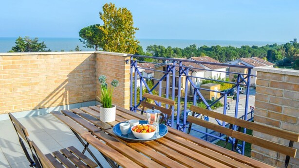 A balcony with a table set for breakfast, overlooking a coastal view. - G.Bay C21 - Second floor apartment with balcony overlooking the sea and the pool (Foggetta)
