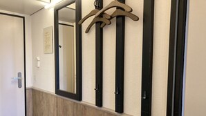 A hallway with a wooden floor, a white door, and a wall-mounted mirror. - Berolina 331 - Sunset - Fantastic sunsets included! (Dahme)