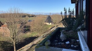 A view from a window overlooking a rural landscape with a small house, trees, and a clear sky. - Berolina 331 - Sunset - Fantastic sunsets included! (Dahme)