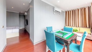A modern living room with a pool table, a sofa, and a TV. - Ruiya Holiday Hotel (Dianjiang County)