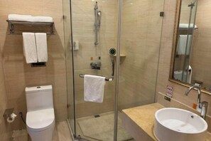 A modern bathroom with a glass-enclosed shower, a toilet, and a sink with a mirror above. - Vienna Hotel (Taizhou Luqiao Passenger Center) (Taizhou)