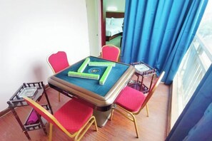 A small room with a table, chairs, and a window with curtains. - Deyuan Hotel (Shaoguan Nanhua Temple) (Shaoguan)