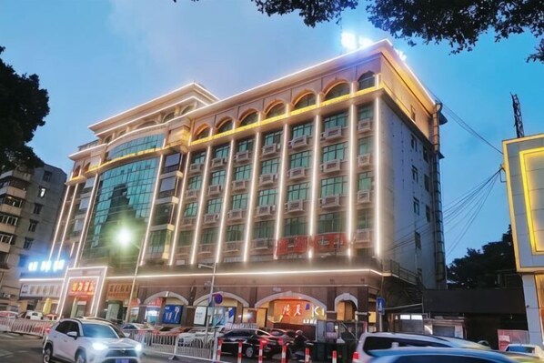 A multi-story hotel with a modern facade, large windows, and a prominent entrance.
