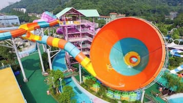 Parque acuático con varias toboganes de agua y un tobogán central grande.