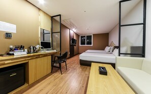 A hotel room with a wooden desk, a bed, a sofa, and a TV. - Jinju Chungmugongdong Cozy (Jinju)