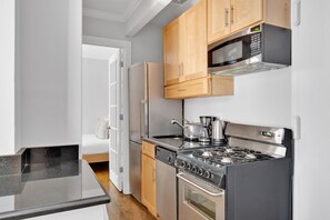 Fridge, microwave, oven, stovetop - Bright East Village 1BR w/ in-unit W/D, close to Park, by Blueground (Downtown)