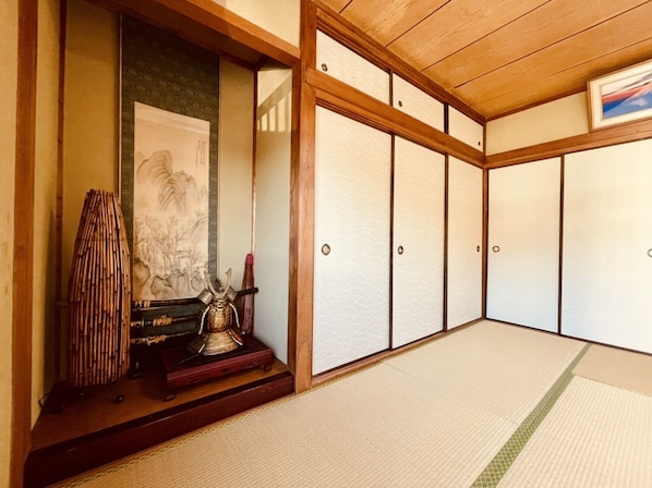 A traditional Japanese room with tatami flooring, sliding doors, and a shoji screen.