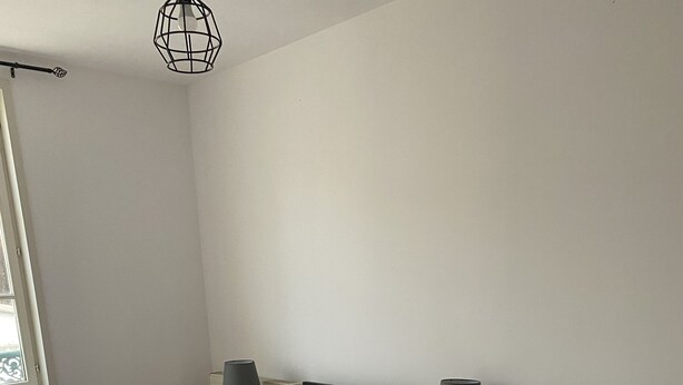 A bedroom with two beds, each with a white bedspread and a wooden headboard. There are bedside tables with lamps and a radiator on the wall. - Lakefront apartment and walks (Rives)