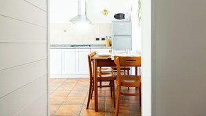 A kitchen with white cabinets, a stove, and a microwave. - APARTMENT IN SEA VIEW RESIDENCE, 200 METERS FROM THE BEACH WI FI (Alcamo)
