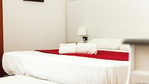 A hotel room with a bed, white bedding, a red throw blanket, a white lamp, and a painting on the wall. - APARTMENT IN SEA VIEW RESIDENCE, 200 METERS FROM THE BEACH WI FI (Alcamo)