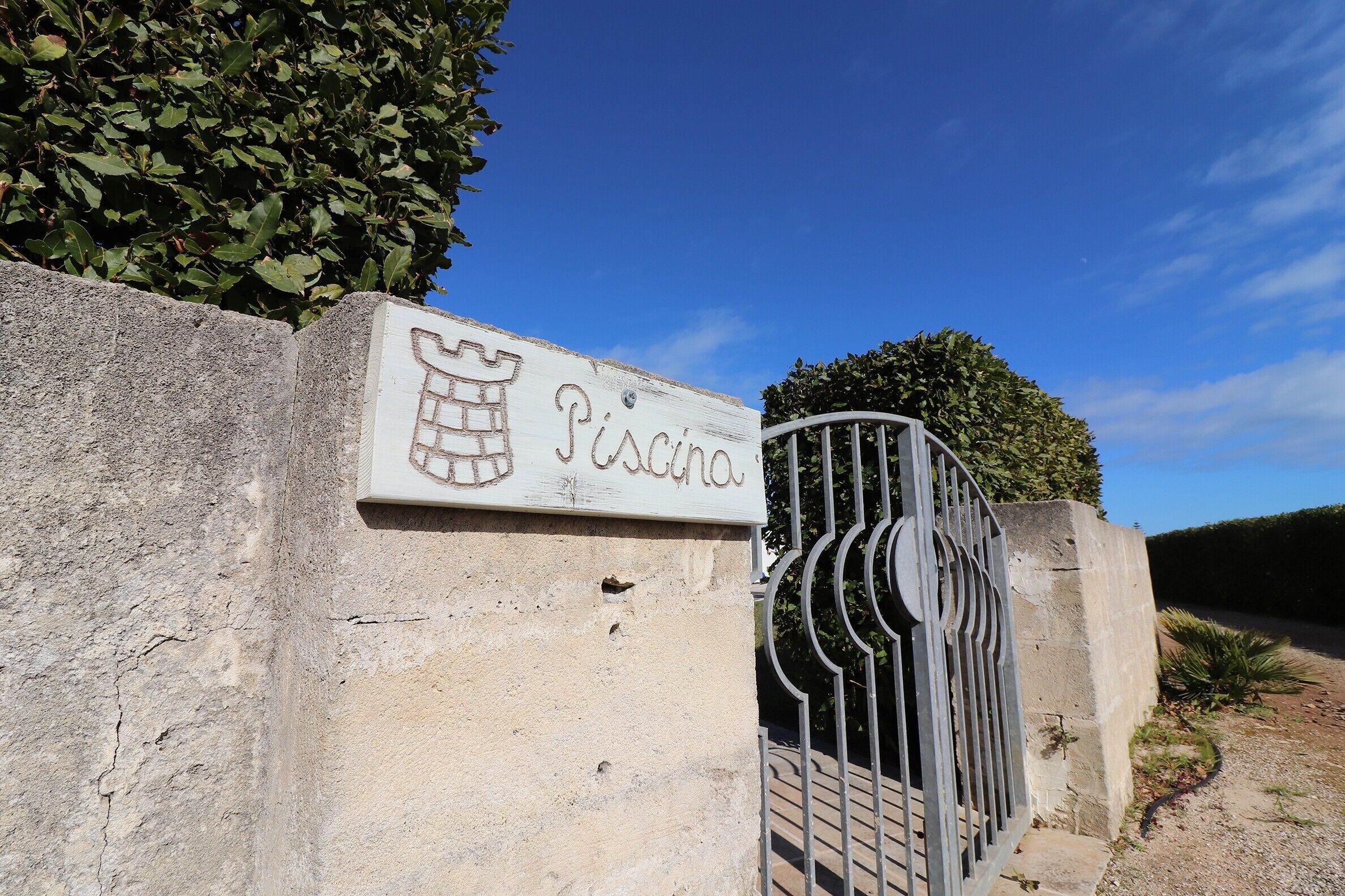 Un panneau indiquant le mot « Piscina » et représentant un dessin de piscine.