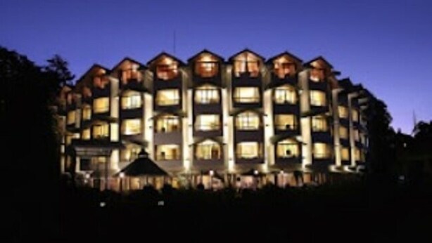 A multi-story hotel with a symmetrical facade, evenly spaced windows, and a central entrance. - Zone Connect Darjeeling (Darjeeling)