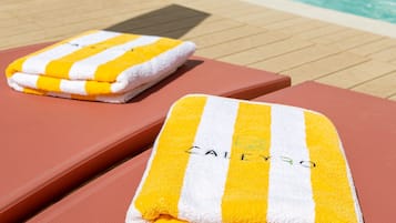 Relax by the pool with comfortable lounge chairs and a tranquil atmosphere.