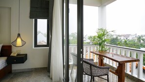 Relax on the balcony with a wicker chair and enjoy the view of the surrounding neighborhood.