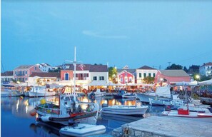 Boats docked in a picturesque marina surrounded by historic buildings.