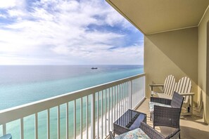 A balcony with wicker furniture and a view of the ocean. - Panama City Beach Condo w/ Free Beach Service! (Panama City Beach)