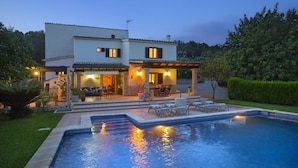 A two-story house with a swimming pool, outdoor seating, and a well-lit patio area. - Ca'l Gall - Two Bedroom Villa, Sleeps 4 (Crestatx)