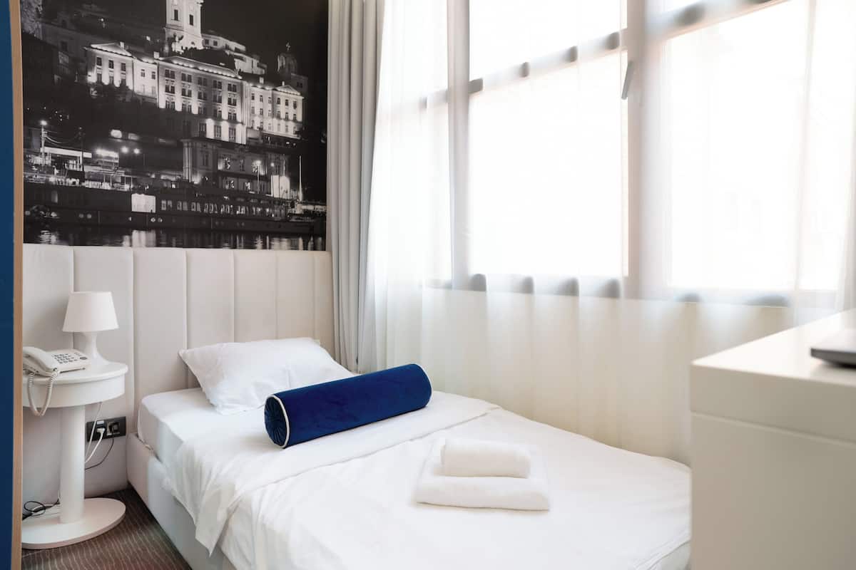 Comfort Room | Premium bedding, memory-foam beds, desk, laptop workspace