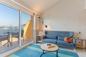 Suite, elveutsikt | Oppholdsområde | En 49-tommers LCD-TV med kabel-kanaler samt TV