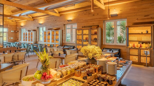 A spacious dining area with wooden beams, large windows, and a buffet with various food items. - Pestana Douro Riverside - Preferred Hotels & Resorts, Lifestyle (Gondomar)