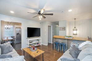 Living room shown opening to the kitchen. Bar area for additional seating.