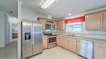 Enjoy cooking in this well-equipped kitchen with a refrigerator, microwave, oven, and dishwasher.