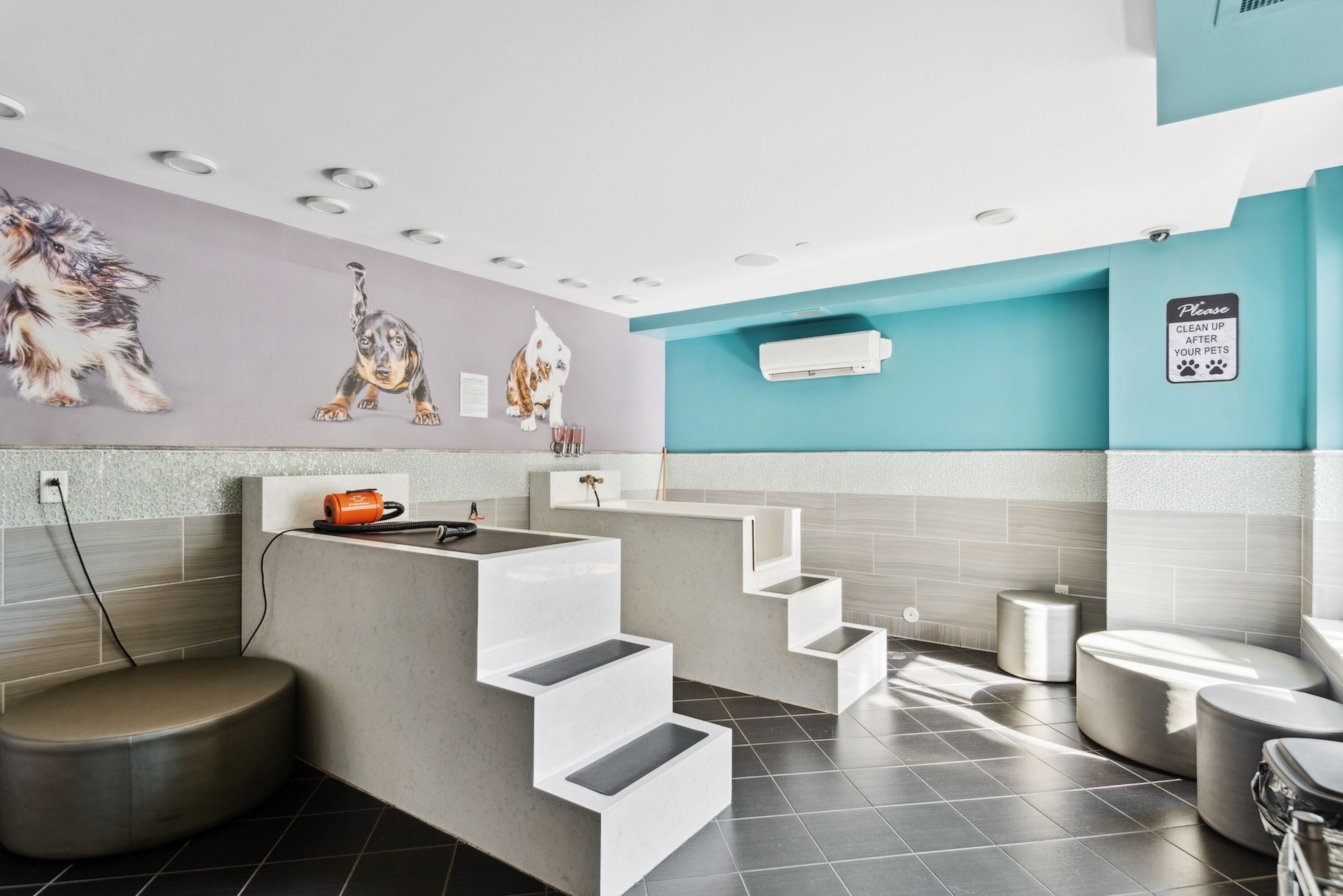 A modern bathroom with a grey and white color scheme, a sink, a toilet, and a shower area.
