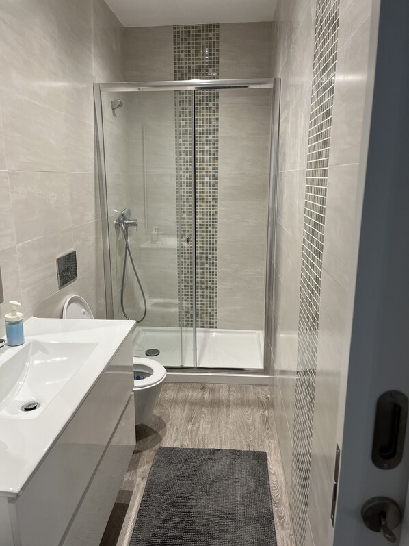 Shower, hair dryer, towels, soap