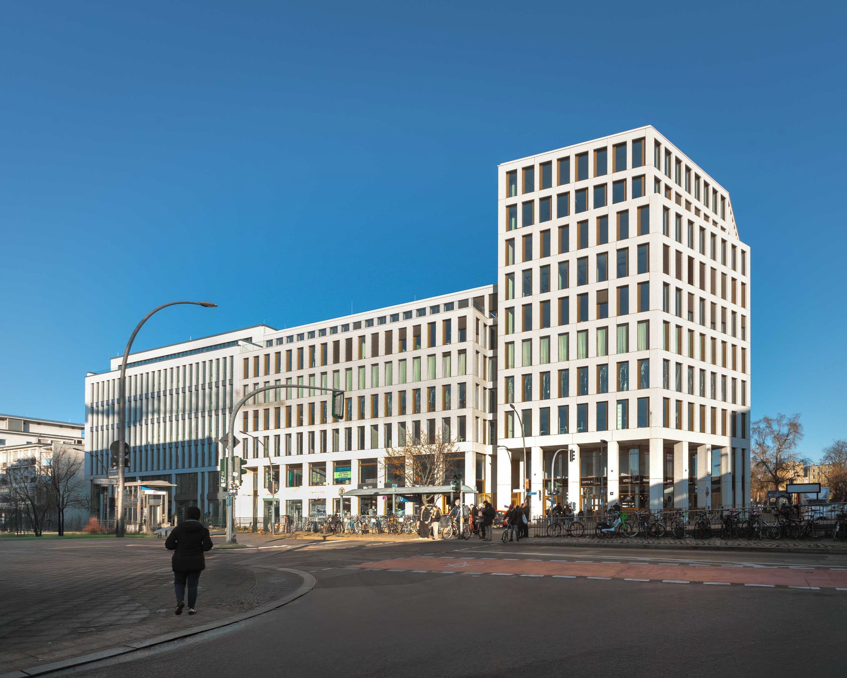 Un edificio moderno con fachada de diseño geométrico, amplias ventanas y techo plano.