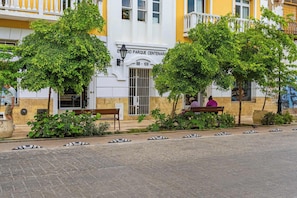 A building with a sign reading 'EDIFICIO PARQUE CENTENARIO 8B-108' and a bench in front. - w* | Charming 2BR w/ Pool & Terrace in Getsemani (Cartagena de Indias)